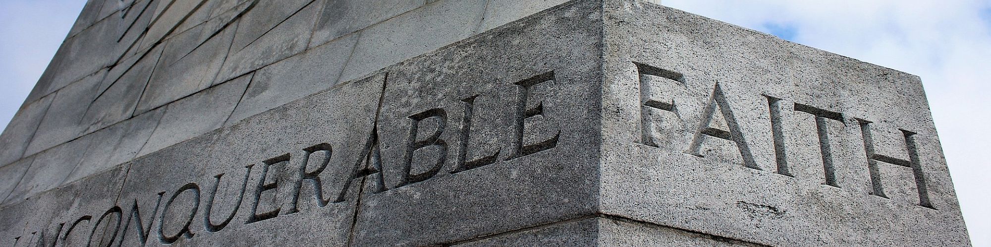 A stone monument with the words 